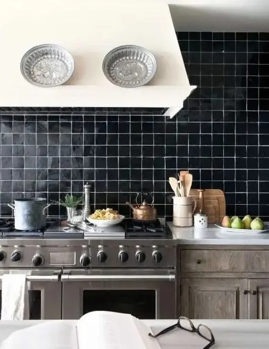 a shiny black tile backsplash with white grout is a statement idea for any kitchen with a retro feel