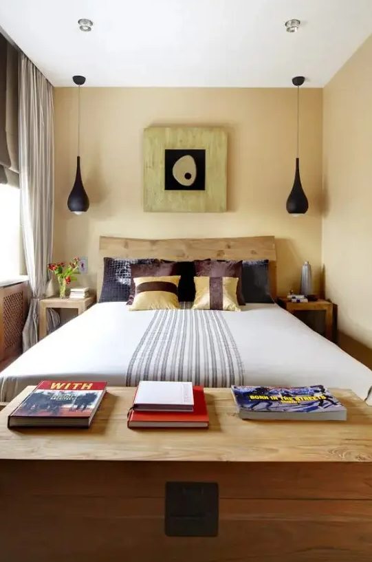 a small eclectic bedroom with a wooden bed, black pendant lamps, catchy printed textiles and a cool artwork with a touch of Asia