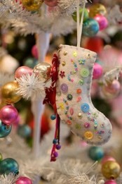 a neutral stocking with colorful beads and sequins is a lovely and bright Christmas ornament you can DIY