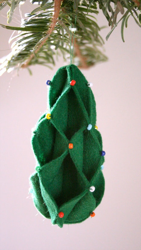 a green tree Christmas ornament of felt with colorful beads is a lovely and bold decoration to rock