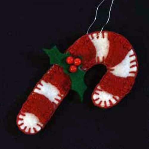 a red and white candy cane Christmas ornament with beads and leaves is a bold and fun idea of a decoration