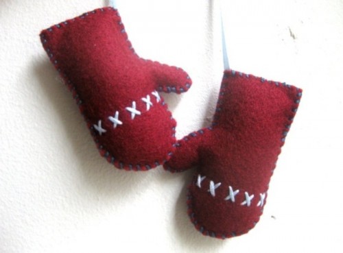 red felt mittens with white embroidery are fun and bold Christmas ornaments you can easily make yourself