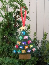 a green felt Christmas tree ornament with mini colroful felt pieces and beads is a lovely idea to try right now