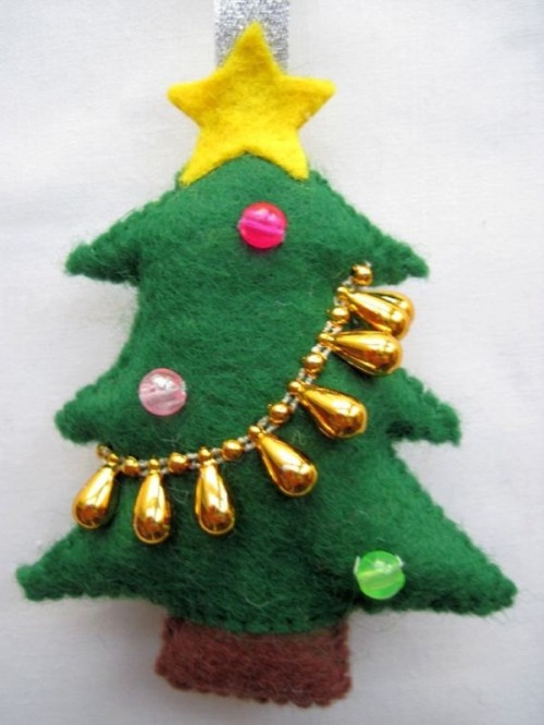 a bold green felt Christmas tree ornament with colorful beads and a yellow star topper is a very fun and bold touch to your tree
