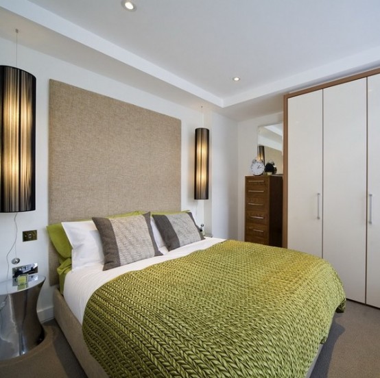 an oversized upholstered headboard makes the bedroom look larger and more welcoming and cozy