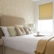 only neutrals used for decor of this bedroom, makes the small space look larger and cozier