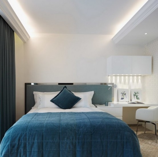 lots of white and built-in lights make the small space larger and more extended and create a welcoming feel