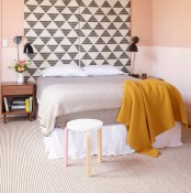 a soft pastel bedroom looks larrger thanks to geometric extended panels over the bed
