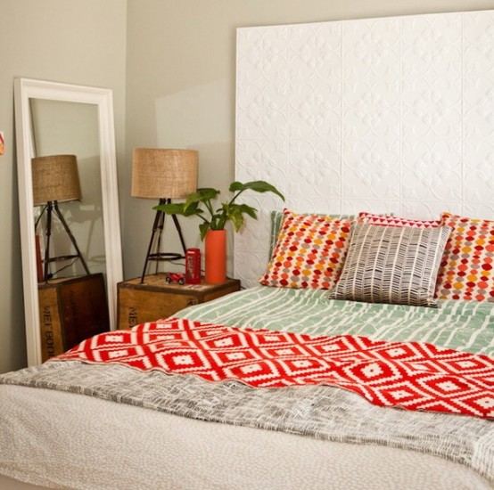 an extended patterned headboard done with panels is a lovely idea for a small space, bright bedding adds to the room