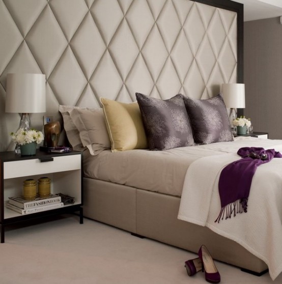 a neutral bedroom with an oversized extended upholstered headboard looks luxurious and very large