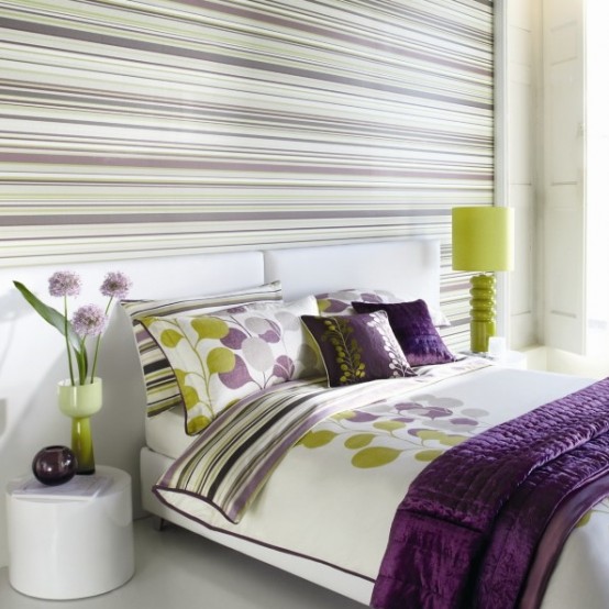 an accent wall with horizontal stripes makes the bedroom look wider and bigger at the same time