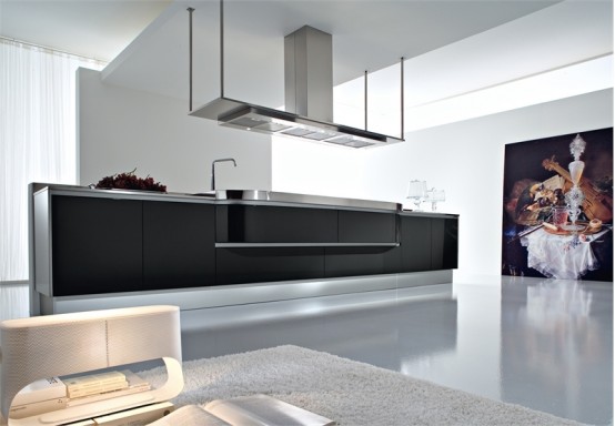 a minimalist white kitchen with a large black kitchen island and a suspended hood, a statement artwork on the wall
