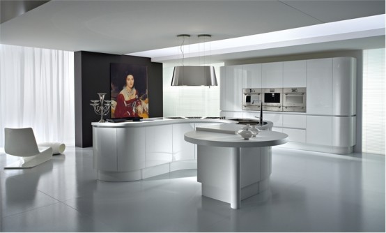 an all-white kitchen with curved furniture, a large curved storage unit with built-in appliances and a large statement artwork