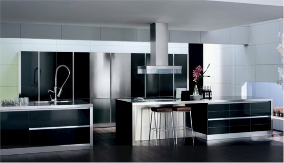 a black, white and silver modern kitchen with built-in appliances and storage units, with white countertops and a suspended hood