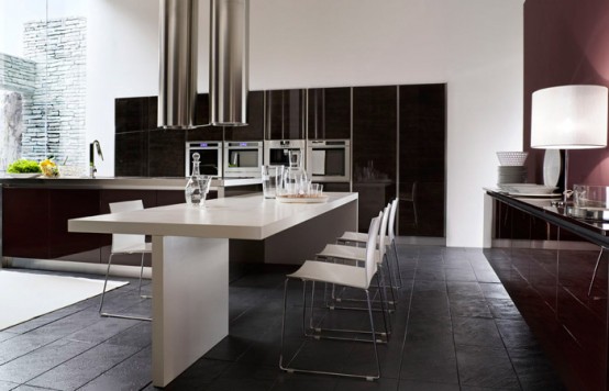 a stylish contemporary black and white kitchen with sleek black storage units, a black kitchen island and a white dining table, white chairs and pipe lamps over the island