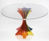 a colorful and creative dining table with a bright glass leg and a clear glass tabletop is a lovely idea for a modern interior