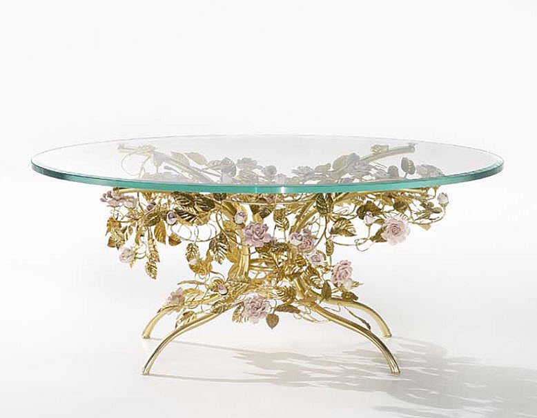 an eye catchy and refined dining table with a beautiful gold leaf and pink flower table base plus a glass tabletop is a lovely idea