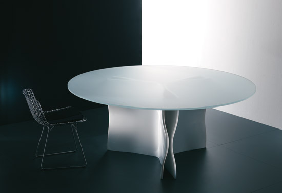 a cool modern dining table with a metal base and a round frosted glass tabletop is a cool and modern idea for any dining space