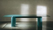 a beautiful turquoise dining table with a semi-sheer turquoise glass tabletop and matching legs is a bold and cool idea for a bright modern dining room