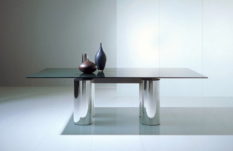 an elegant modern dining table of a black glass tabletop and polished metal legs is a cool and bold solution for a modern space