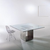 a stylish modern dining table with a square glass tabletop and a polished metal base is a stylish solution for a modern dining room