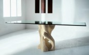 a stylish dining table with a rectangular glass tabletop and a carved wooden base is a cool and bold idea for a modern dining room
