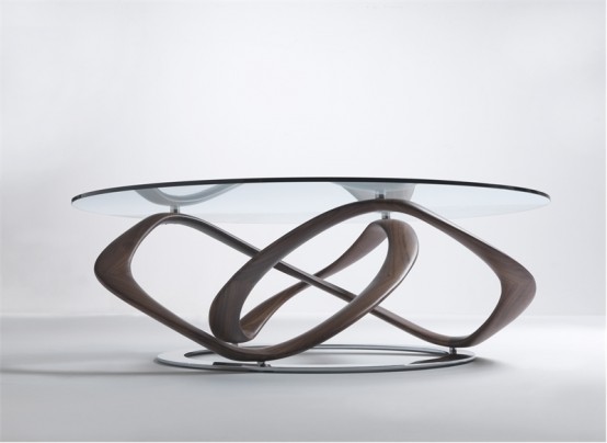 an eye-catchy and bold dining table with a unique swirl base and a round glass tabletop plus a metal base is a chic and cool idea for a modern and quirky dining room