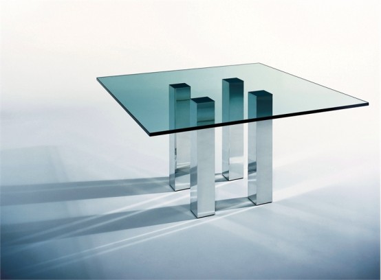 an ultra-modern dining table with a glass tabletop and metal legs as pillars is a stylish idea for a modern or minimalist dining room