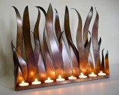 a metal holder inspired by grass or flashes of fire is a unique solution for your home