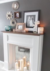 modern fireplace styling with a vintage mirror as a backdrop and some candles in front of it