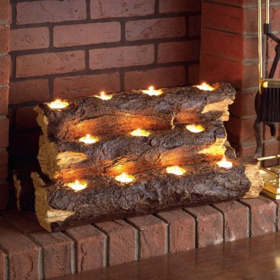 wooden logs with tealights placed inside create a more natural look of a burning fireplace