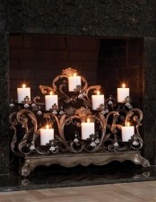 an exquisite candelabra with vignettes and hanging crystals for chic fireplace decor