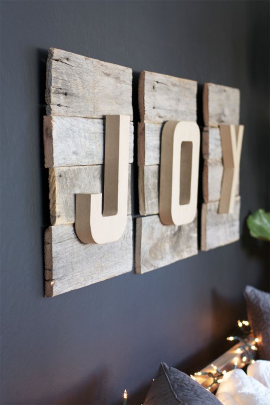 a pretty rustic Christmas decoration made of reclaimed wood plaques and wooden letters that cna be easily DIYed anytime