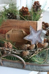a crate and a tray with evergreens, pinecones, a metal star are all you need for a lovely relaxed rustic look
