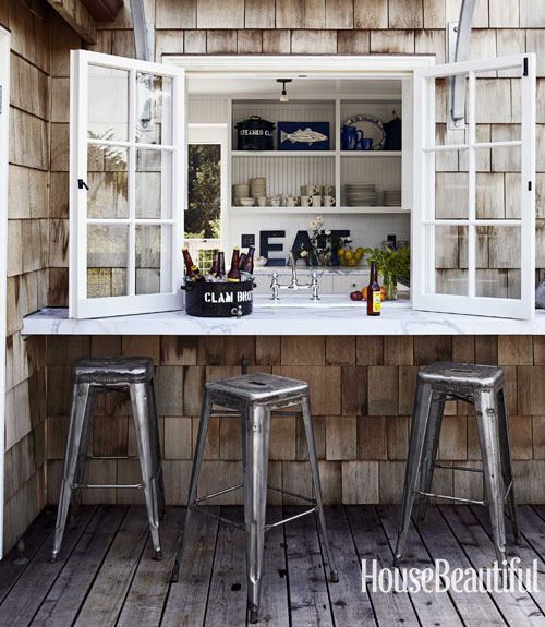 a kitchen with a pass through window and an outdoor windowsill as a floating table is a great idea to eat outdoors when the weather allows