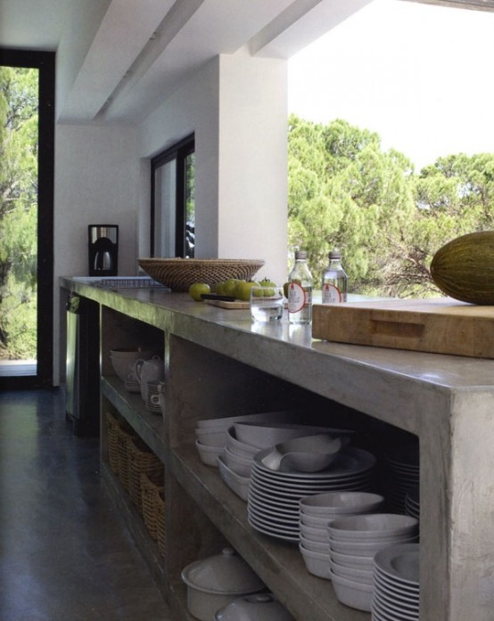 a contemporary kitchen with a concrete cabinet and a large window that can be opened to bring some fresh air and sunlight inside