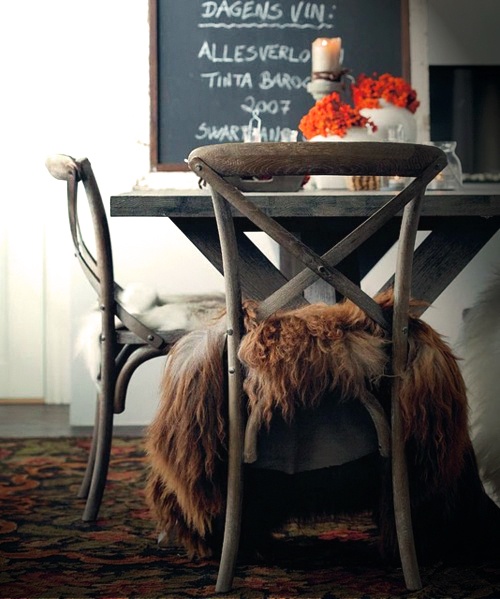 vintage wooden chairs with lush faux fur covers are cool for completing a cozy rustic space for the fall or winter