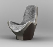 a modern sculptural chair with a matching fur cover on the back and seat is ultimate for having a rest in the evening