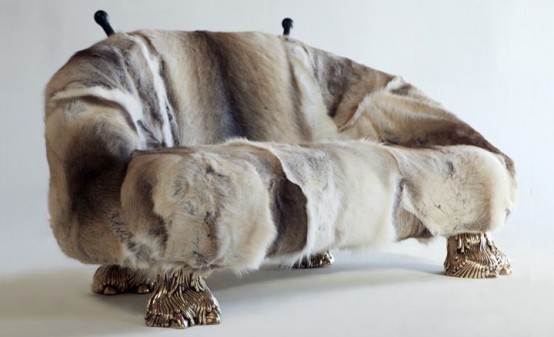 a quirky sofa covered with fur and with gold legs imitating animal ones is a crazy piece that will make a statement