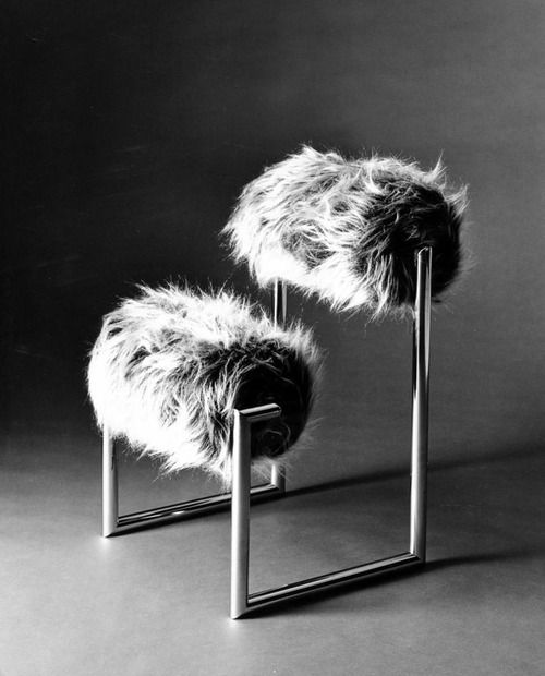 a catchy chair made of metal framing and two faux fur rollers is a bold and chic idea for a modern space