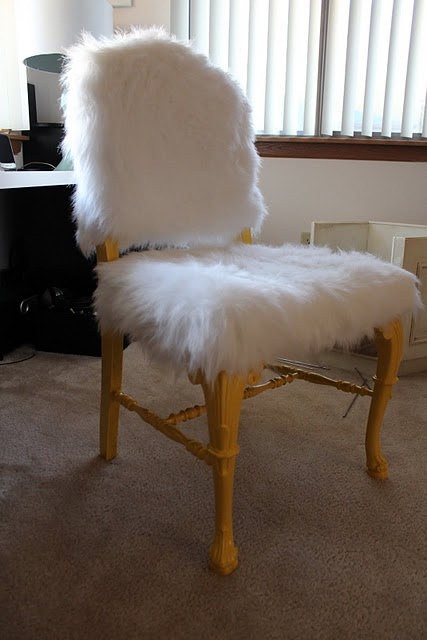 a white faux fur chair with refined vintage legs is a stylish piece to use in your space