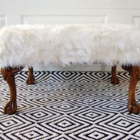 a refined white faux fur bench with animal legs is a quirky and fun glam piece for a modern space