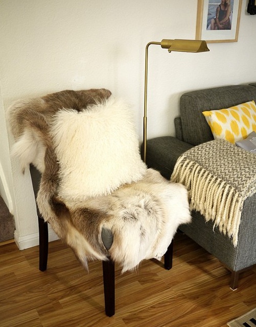a usual chair covered with faux fur adds coziness to the space and invites you to sit on it and relax