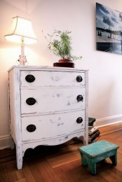 a pretty shabby chic dresser with vintage black knobs is a very cool and lovely idea for a modern space, it looks amazing