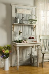 a whitewashed garden piece with a door, a shelf and a half table is a beautiful idea for a vintage or shabby chic garden