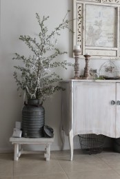 a vintage whitewashed cabinet and a mini stool will help you create a refined vintage look effortlessly