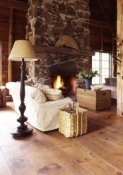 wooden walls and a floor plus a large stone clad fireplace creta e anice backdrop for rustic decor