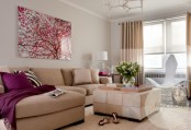 a stylish living room with tan seating furniture and color block curtains, a tan rug, a color block pouf and a cherry blossom print is chic