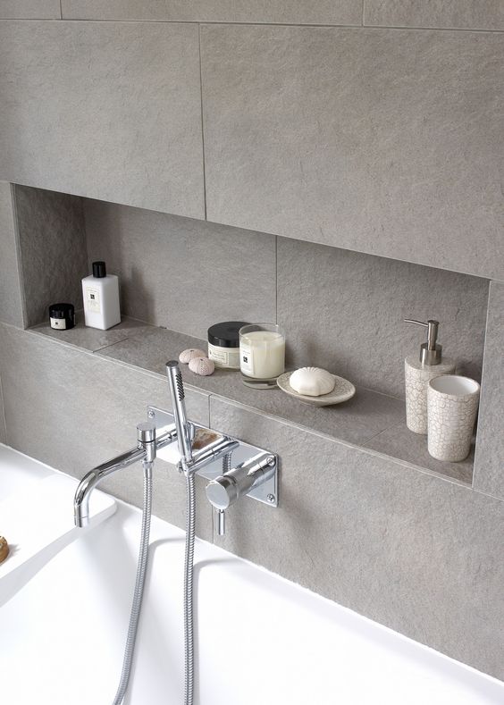 a grey tile bathroom wall with a large niche for storage is a great idea as this niche saves a lot of floor and storage space