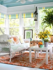 a colorful sunroom design with boho touches